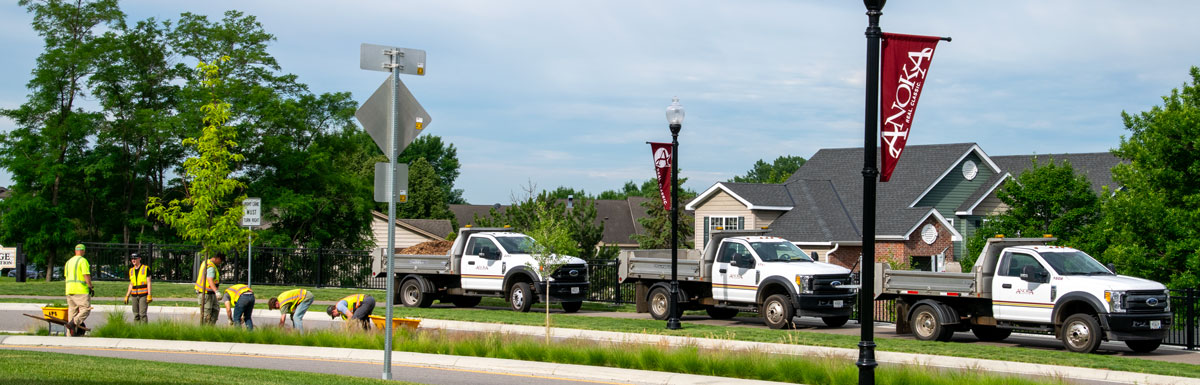 men working on landscaping by street